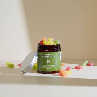 Inside-Out Care: Why True Beauty Sleep Starts with Stress Relief 13 An open amber glass jar filled with colorful premium wellness gummies sitting on a clean studio shelf